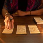 Woman laying out tarot cards on a table