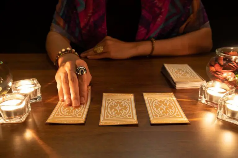 Woman laying out tarot cards on a table