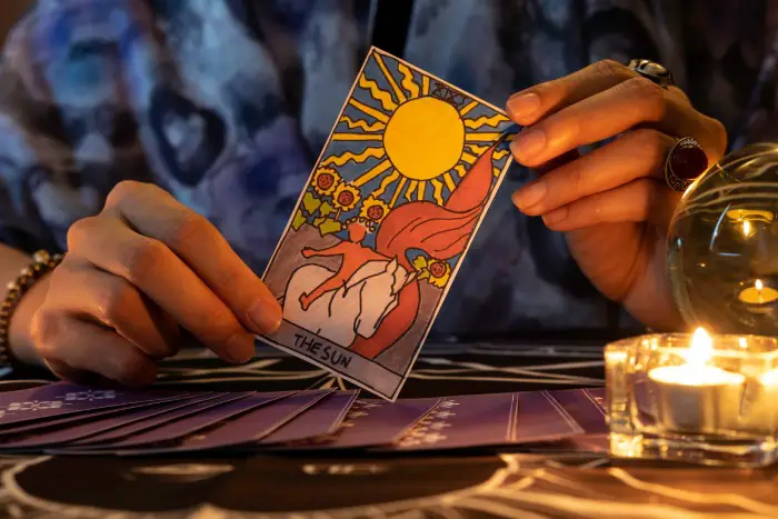 Fortune teller holding the Sun card