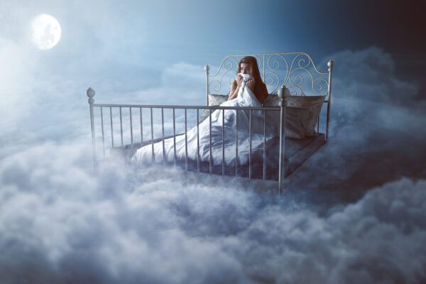 woman scared in bed on clouds