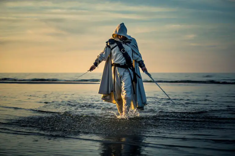 Portrait of assassin in white costume with the sword at the sea
